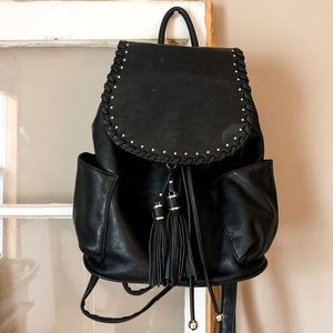 Black faux leather back pack with tassel